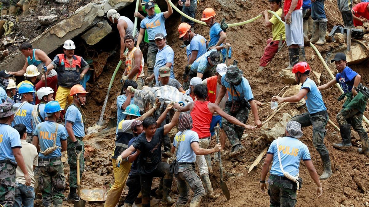 Rescuers carry a body recovered at a landslide after super typhoon Mangkhut hit the country at a mining camp in Itogon Benguet Philippines September 17 2018 REUTERS Harley Palangchao